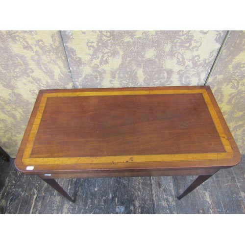 2706 - A 19th century mahogany D end fold-over top tea table crossbanded in satinwood and raised on square ... 