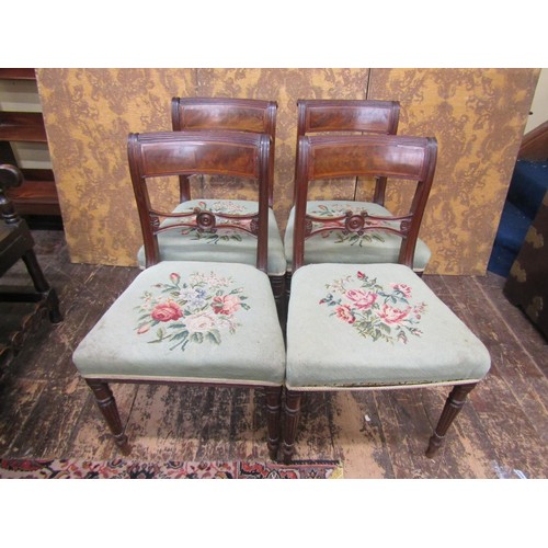 2705 - A set of four Regency mahogany dining chairs with pierced splats, upholstered seats and raised on tu... 