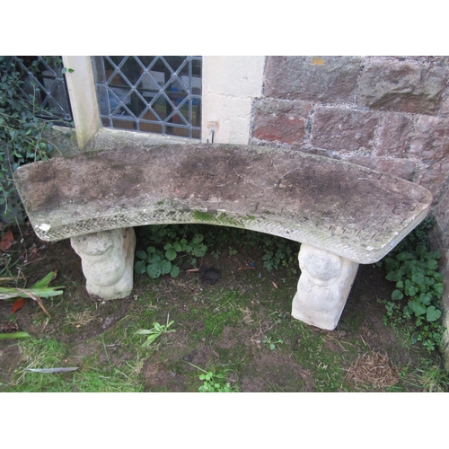 2091 - A weathered cast composition stone three sectional garden bench with curved slab seat raised on wing... 