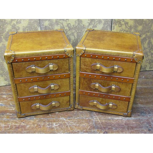 2656 - A pair of studded tan leather three drawer bedside chests