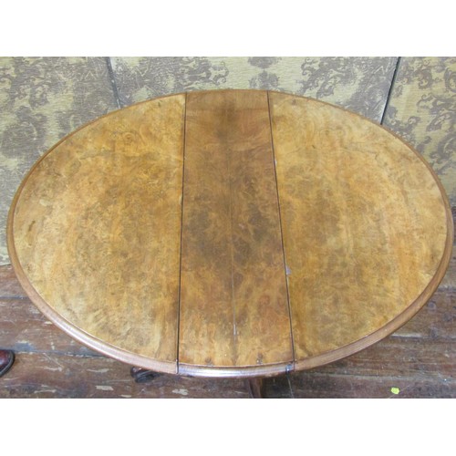 2642 - A small Victorian burr walnut folding tea table enclosing a frieze drawer with segmented compartment... 