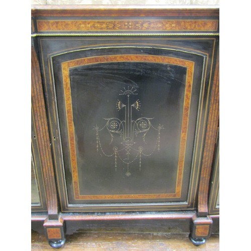 2640 - A Victorian ebonised three door credenza cabinet with amboyna wood highlights, two glazed panelled o... 