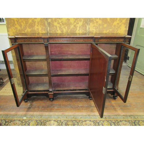 2640 - A Victorian ebonised three door credenza cabinet with amboyna wood highlights, two glazed panelled o... 