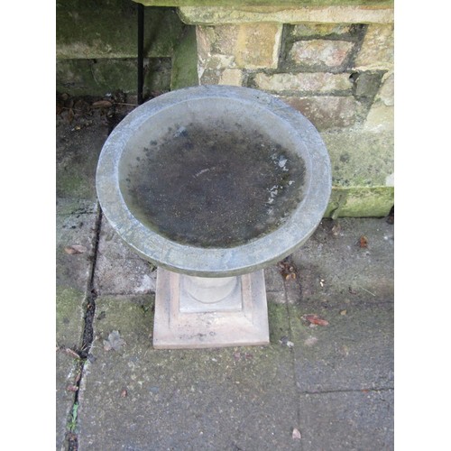 2010 - A composition stone three sectional bird bath with baluster pedestal, circular top on square stepped... 