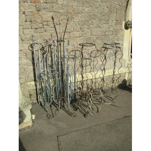 2043 - A quantity of decorative steel patio plant stands in varying designs, the tallest 160cm high