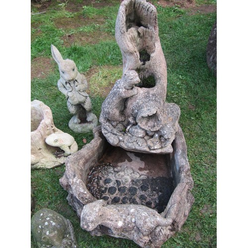 2086 - A weathered composition stone water feature in the form of an otter and habitat together with other ... 