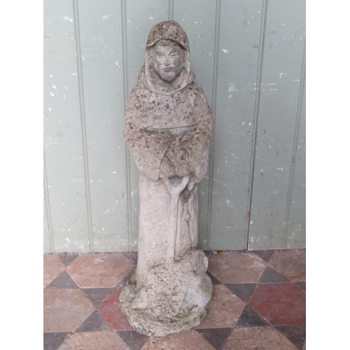 2103 - A weathered stone composition stone figure of a standing monk, 65 cm high.