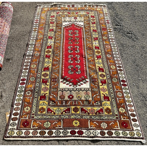 1778 - A Persian rug with a central rectangular panel and stylised flowers, 210 x 118cm approx