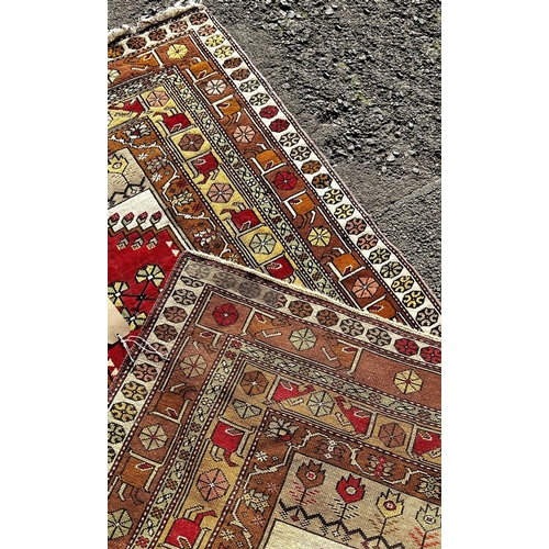 1778 - A Persian rug with a central rectangular panel and stylised flowers, 210 x 118cm approx