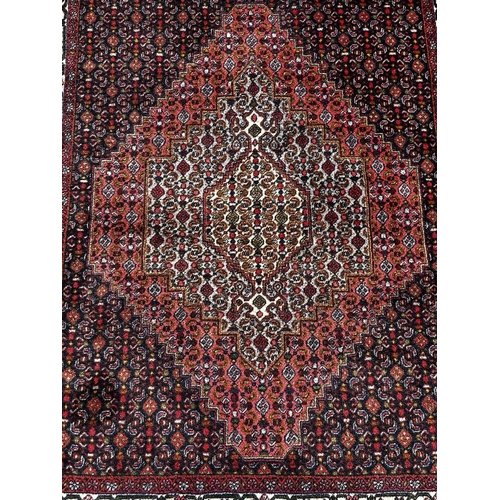 1781 - A Heriz style carpet with a central stepped diamond medallion and an all over geometric pattern, 156... 