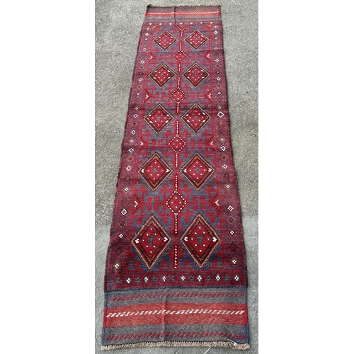 1775 - A Meshwani runner, with intermittent diamond motifs in red and blue tones,228cm x 57cm