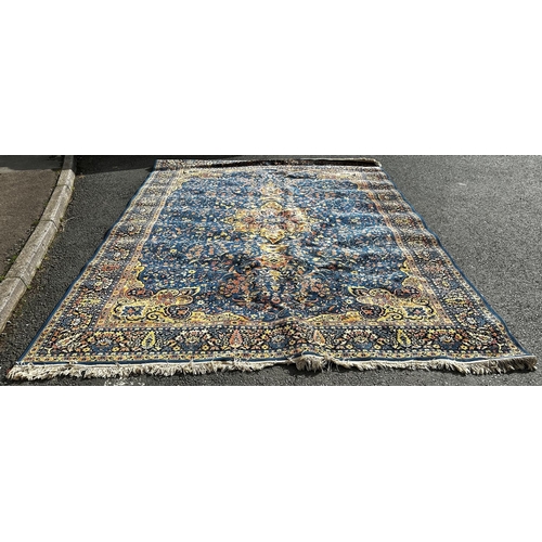 1793 - A Sarouk carpet with a central floral medallion and an over all floral pattern on a blue ground, 360... 