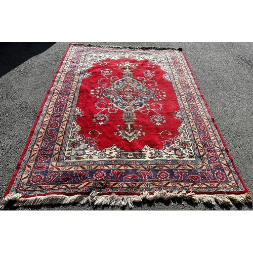 1807 - A large Turkish carpet with an extended central panel on a red ground and running floral borders,300... 