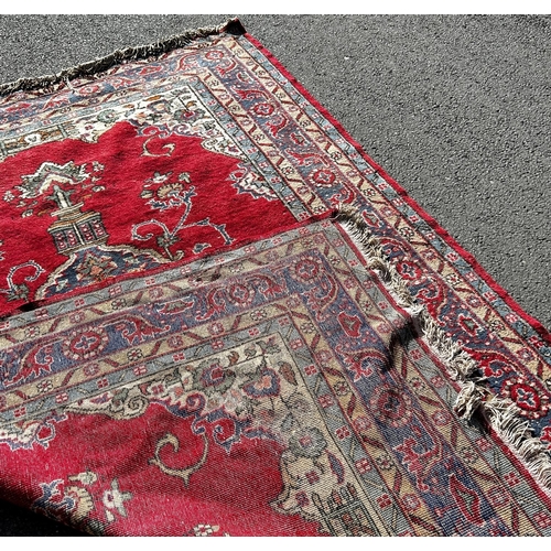 1807 - A large Turkish carpet with an extended central panel on a red ground and running floral borders,300... 