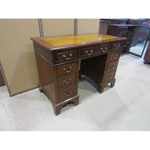 2297 - A small 19th century mahogany pedestal desk, with a tooled leather top over an arrangement of nine d... 