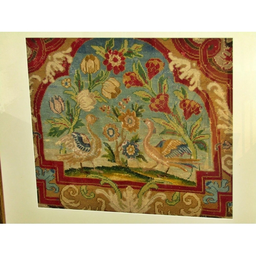 83 - A later framed 19th century embroidered tapestry panel decorated with a pair of Asiatic birds flanki... 