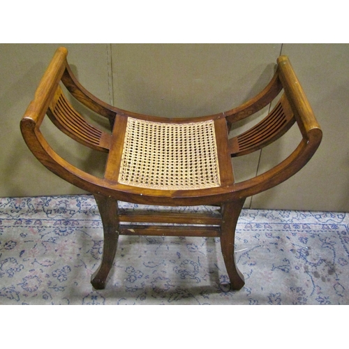 2264 - An x framed bergere seated piano stool, 69 cm high.