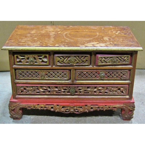 2296 - A small Chinese carved hardwood chest of six drawers, raised on scrolling supports, with carved pane... 