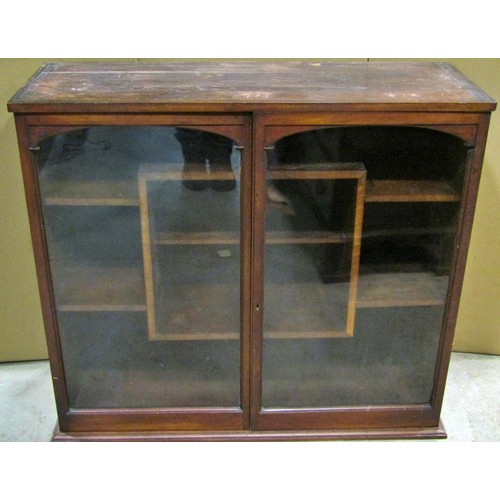 2298 - A small late 19th /early 20th century mahogany cabinet, the glazed panelled doors opening to reveal ... 