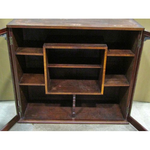 2298 - A small late 19th /early 20th century mahogany cabinet, the glazed panelled doors opening to reveal ... 