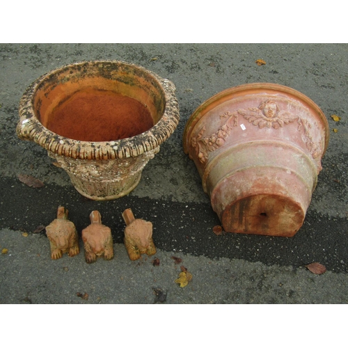 2076 - A weathered terracotta garden planter of circular tapered form with floral swag, lions mask and furt... 