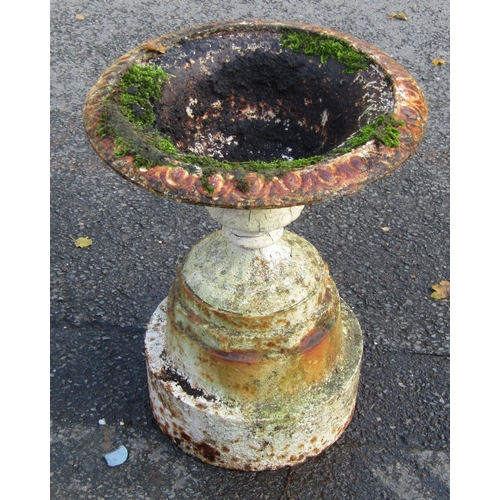 2124 - An old painted and weathered cast iron garden urn, the shallow circular bowl with flared egg rim, fi... 