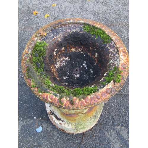 2124 - An old painted and weathered cast iron garden urn, the shallow circular bowl with flared egg rim, fi... 