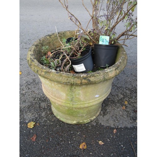 2063 - A weathered terracotta circular ribbed planter with moulded rim 58 cm diameter x 42 cm high together... 