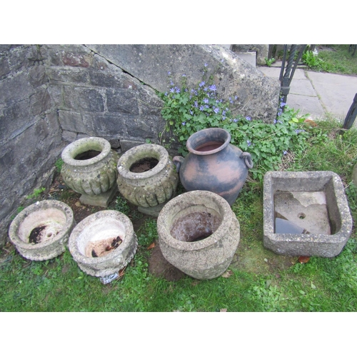 2083 - A pair of nicely weathered cast composition stone garden urns with circular lobbed bodies and square... 