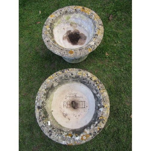 2090 - A pair of weathered composition stone circular lobbed garden urns raised on loose socles, 50 cm diam... 