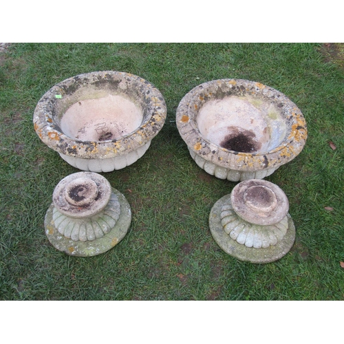 2090 - A pair of weathered composition stone circular lobbed garden urns raised on loose socles, 50 cm diam... 