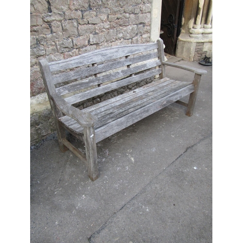 2093 - A Swan Hattersley weathered teak three seat garden bench with slatted seat and back beneath a curved... 