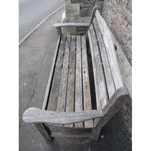 2093 - A Swan Hattersley weathered teak three seat garden bench with slatted seat and back beneath a curved... 