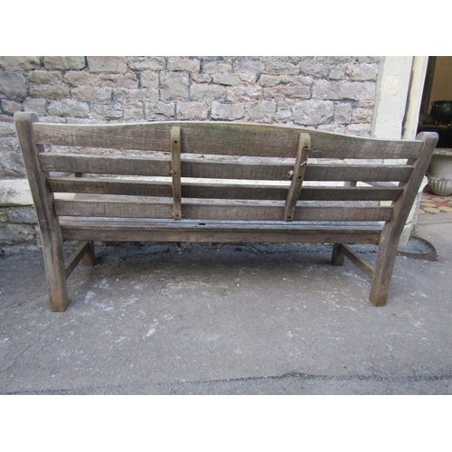 2093 - A Swan Hattersley weathered teak three seat garden bench with slatted seat and back beneath a curved... 