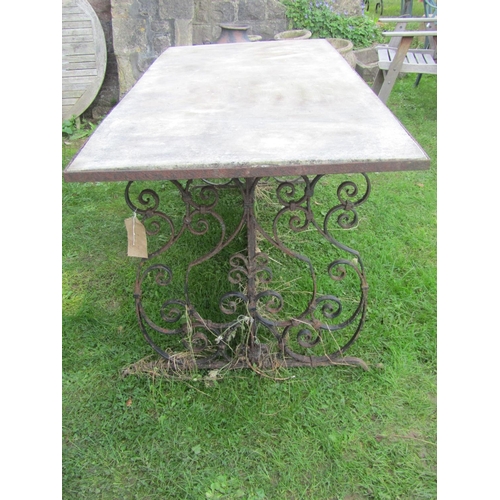 2094 - A large weathered  ironwork table with scrolled framework and inset marble top, 75cm high, 197 long ... 