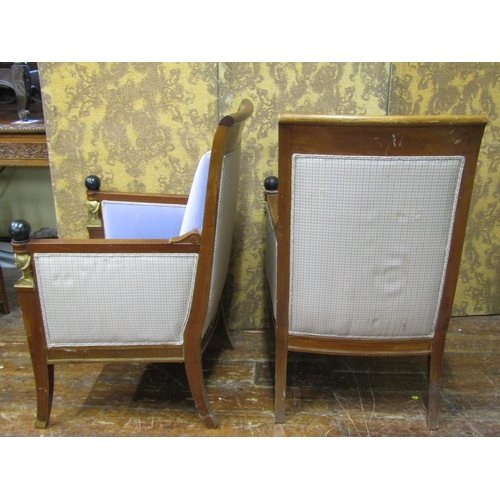 2652 - A pair of Empire style elbow chairs, raised on sabre supports, the show wood frames mounted with ebo... 