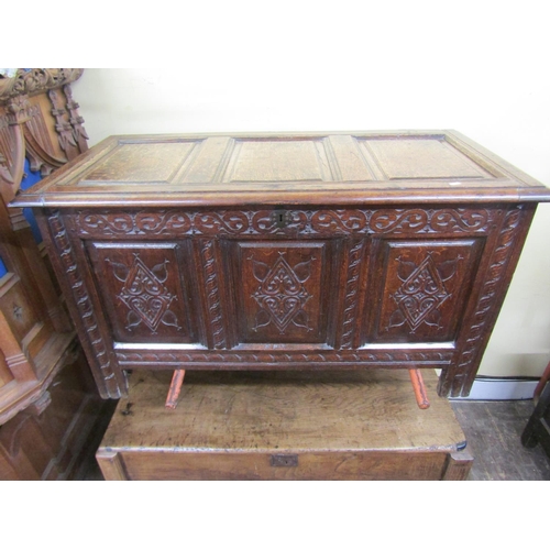 2729 - An 18th century panelled oak coffer with repeating geometric detail, 130 cm long x 72 cm height