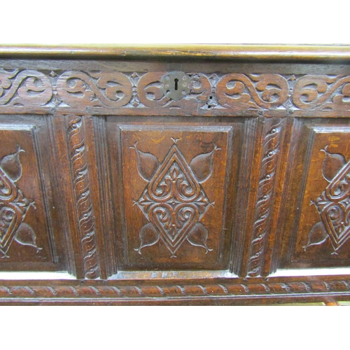 2729 - An 18th century panelled oak coffer with repeating geometric detail, 130 cm long x 72 cm height