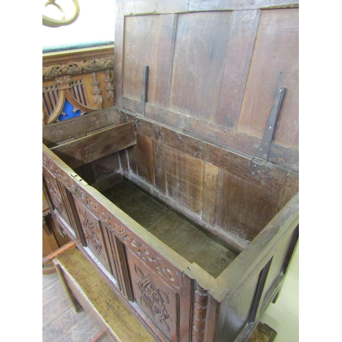 2729 - An 18th century panelled oak coffer with repeating geometric detail, 130 cm long x 72 cm height