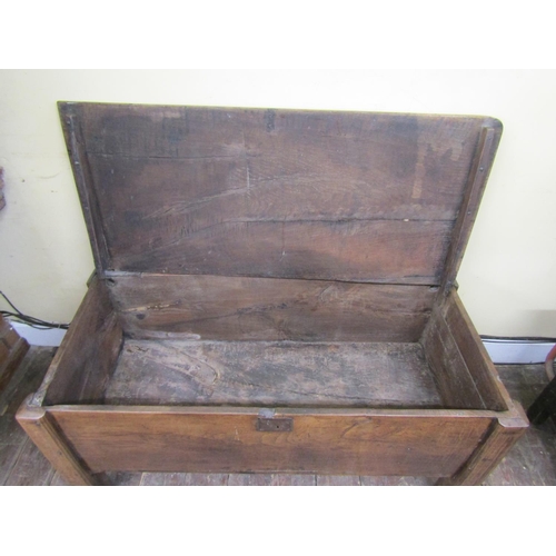 2730 - An early oak  plank coffer on raised supports
140cm wide