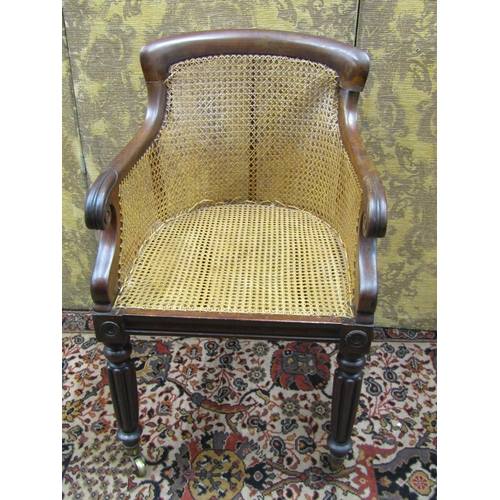 2740 - Regency mahogany bergere library chair on fluted supports