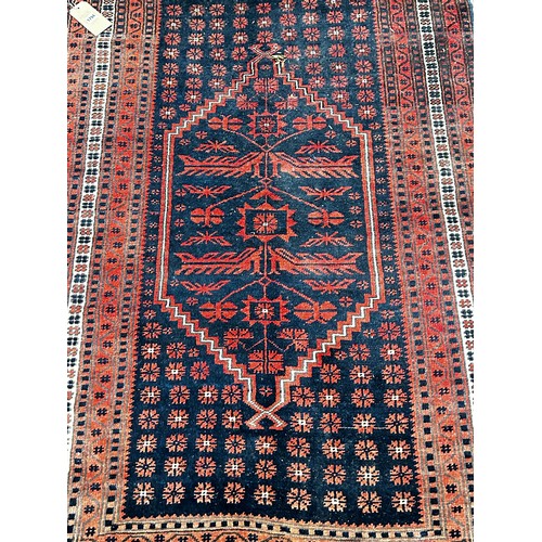 1816 - A Persian style rug with a stepped medallion, in tones out red and blue, 175 x 115cm approx