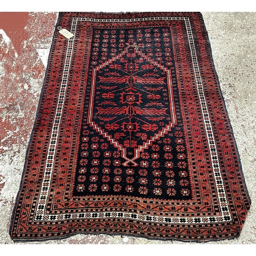 1816 - A Persian style rug with a stepped medallion, in tones out red and blue, 175 x 115cm approx