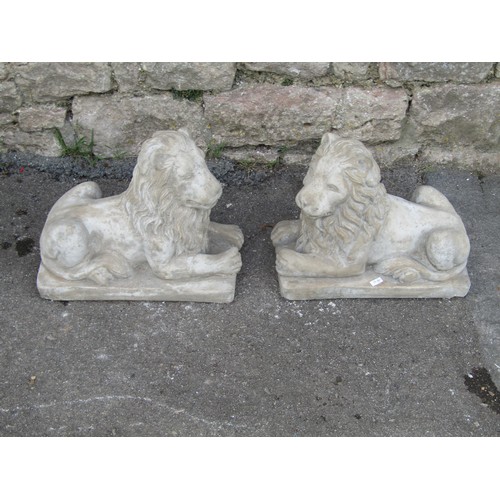 2116 - A symmetrical pair of reconstituted stone garden ornaments in the form of classically presented recu... 