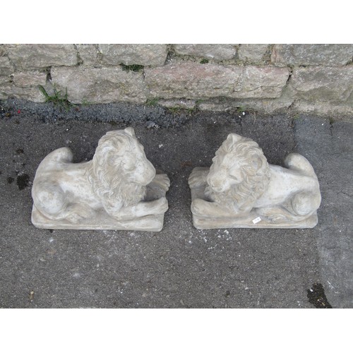 2116 - A symmetrical pair of reconstituted stone garden ornaments in the form of classically presented recu... 