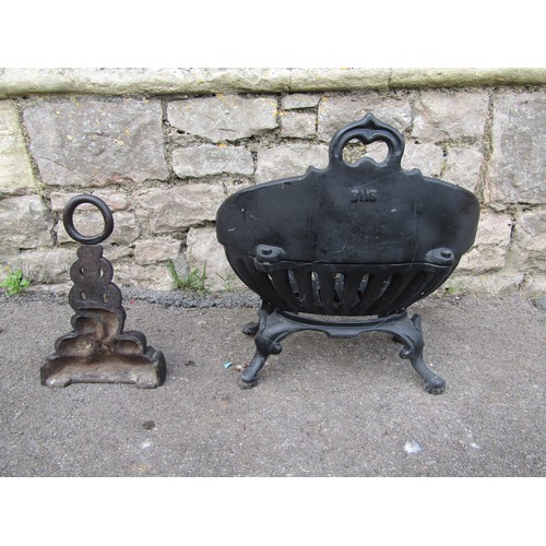 2105 - A small painted cast-iron fire basket, 40 cm high, 38 cm wide together with a cast iron doorstop in ... 