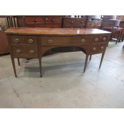 2266 - A very large 19th century bow-fronted mahogany sideboard, the banded top over an arrangement of draw... 