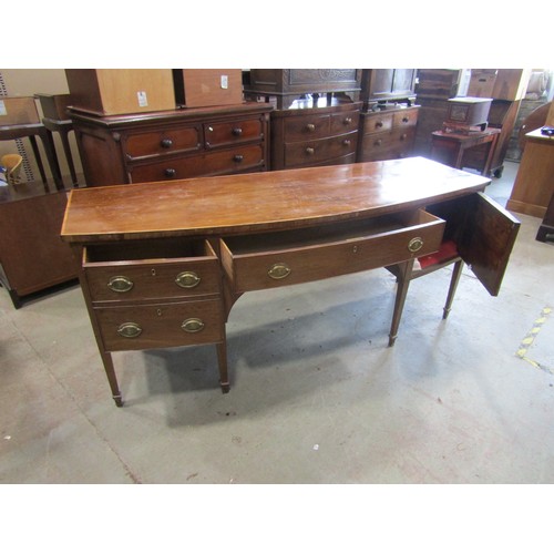 2266 - A very large 19th century bow-fronted mahogany sideboard, the banded top over an arrangement of draw... 