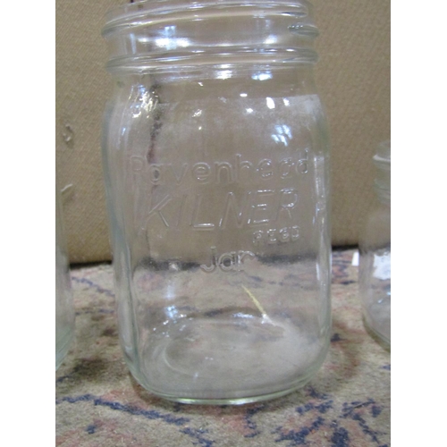 2193 - A collection of Kilner storage jars of varying size together with a quantity of pub pint glasses