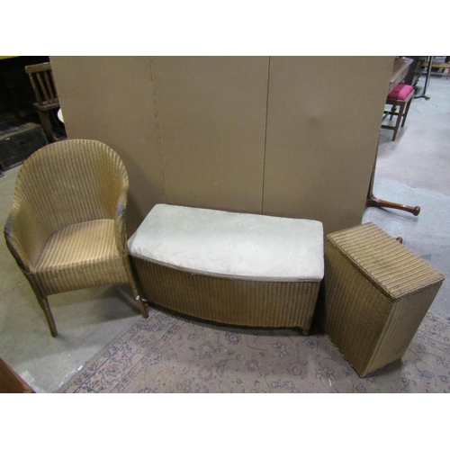 2231 - Three Lloyd Loom items with a gold painted finish, to include a chair, ottoman and laundry box toget... 